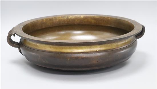 An Uruli bronze 19th century temple bowl length handle to handle 44cm